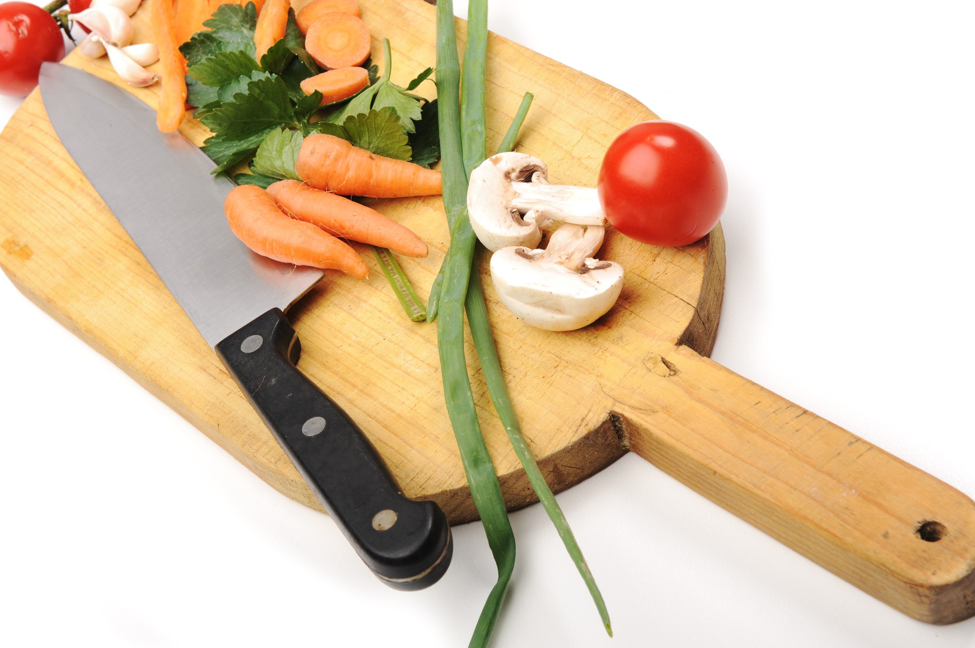 Knife and vegetable prep on a cutting board